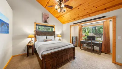 a bedroom with a bed and a desk with a computer at Outdoor Dining Backyard Trails Nearby Cedar Hollow Retreat by AvantStay in Tahoma