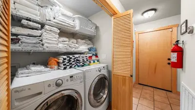 a laundry room with a washer and dryer at Outdoor Dining Backyard Trails Nearby Cedar Hollow Retreat by AvantStay in Tahoma