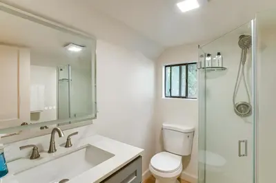 a bathroom with a sink and a toilet and a shower at Hot Tub and Game Room Luxe Cabin, Day Trip to Tahoe in Pollock Pines