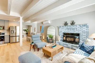 a living room with a couch and a fireplace at Hot Tub and Game Room Luxe Cabin, Day Trip to Tahoe in Pollock Pines