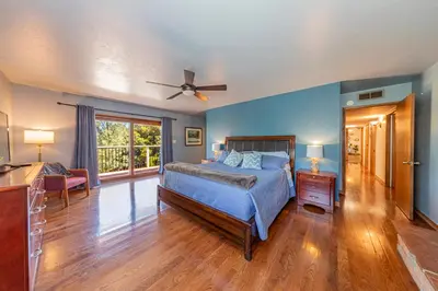 a bedroom with blue walls and a bed and a window at Sierra View Retreat with Newly Installed Hot tub! in Oakhurst