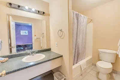 a bathroom with a sink and a toilet at Los Banos Motel in Los Banos
