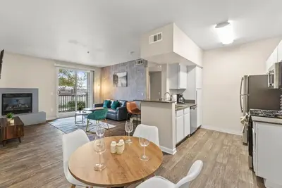 a kitchen and living room with a table and chairs at Luxury King Suite by the Lake - Entire Place in Sparks