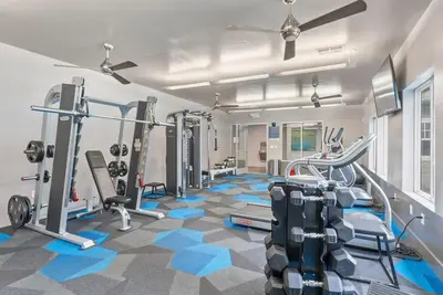 a gym with treadmills and machines in a room at Luxury King Suite by the Lake - Entire Place in Sparks
