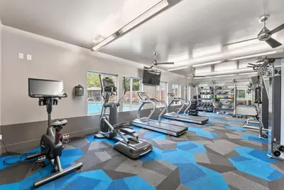 a gym with several treadmills and cardio machines at Luxury King Suite by the Lake - Entire Place in Sparks