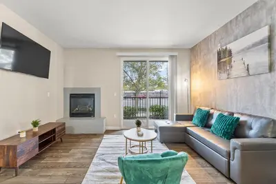 a living room with a couch and a table at Luxury King Suite by the Lake - Entire Place in Sparks
