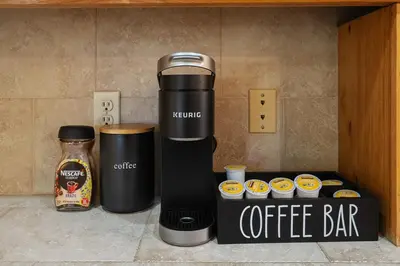 a coffee maker next to a box of cupcakes at WoodUStau in Coarsegold