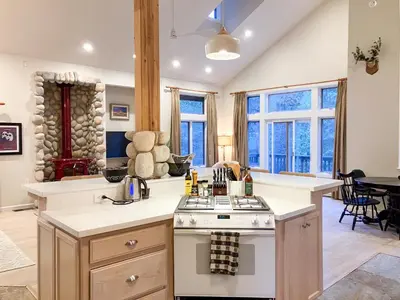 a kitchen with a stove and a counter top at Boom Chalet Yosemite in Oakhurst