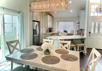 a kitchen with a table with chairs and a dining room at Contemporary, newly renovated and great location in Fresno