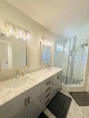 a bathroom with a sink and a shower at Contemporary, newly renovated and great location in Fresno