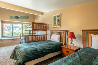 a bedroom with two beds and a window at Updated1849 Townhome #611, Steps to Canyon Lodge 4 Bed/3BA, hot tubs, game rm, sauna! in Mammoth Lakes