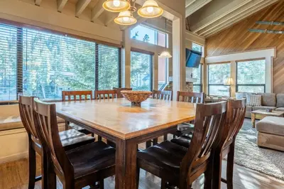 a dining room with a wooden table and chairs at Updated1849 Townhome #611, Steps to Canyon Lodge 4 Bed/3BA, hot tubs, game rm, sauna! in Mammoth Lakes