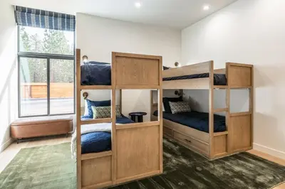 two bunk beds in a room with a window at New Luxury Free Standing 4BR 4 and a halfBA Home Obsidian Reserve #146 Priv Hot Tub, 2-Car Garage Great Views in Mammoth Lakes