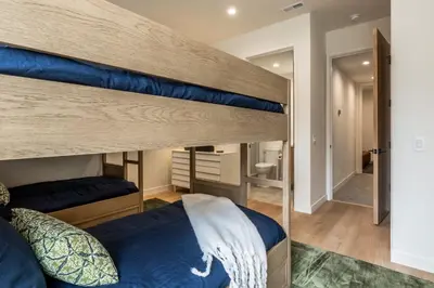 a bedroom with two bunk beds and a bathroom at New Luxury Free Standing 4BR 4 and a halfBA Home Obsidian Reserve #146 Priv Hot Tub, 2-Car Garage Great Views in Mammoth Lakes