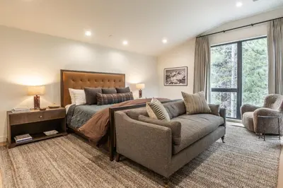 a bedroom with a bed and a couch and a chair at New Luxury Free Standing 4BR 4 and a halfBA Home Obsidian Reserve #146 Priv Hot Tub, 2-Car Garage Great Views in Mammoth Lakes