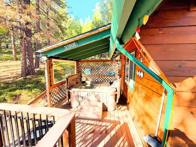 a porch of a cabin with a table and chairs at Rustic and Scenic in Cold Springs