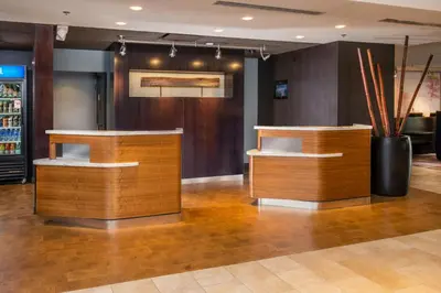 a lobby with a barber shop with wooden furniture at Courtyard by Marriott Fresno Downtown in Fresno