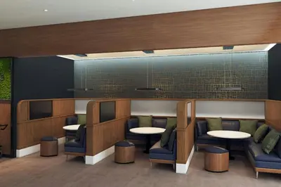 a waiting room with tables and chairs at Courtyard by Marriott Fresno Downtown in Fresno