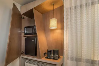 a kitchen with a microwave and a coffee maker and a microwave at Courtyard by Marriott Fresno Downtown in Fresno
