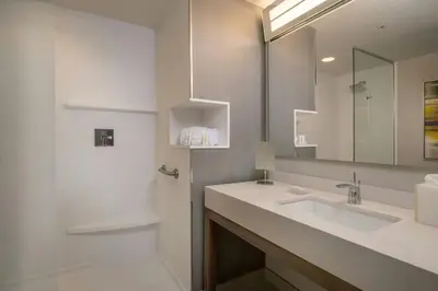 a bathroom with a sink and a mirror at Courtyard by Marriott Fresno Downtown in Fresno