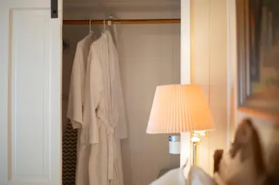 a man laying in a bed next to a lamp at Sleeps 2 Private Entrance, Spa Tub, Near Casino in Tuolumne