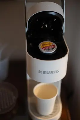 a bottle of kettrite with a cup of coffee at Sleeps 2 Private Entrance, Spa Tub, Near Casino in Tuolumne