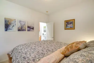a bedroom with a bed and two pictures on the wall at 13 Mi to Slopes Cozy Home with Fenced Yard in Reno in Reno