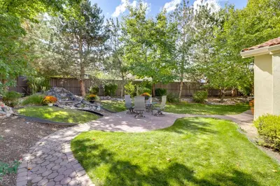 a garden with a patio and a fire pit at 13 Mi to Slopes Cozy Home with Fenced Yard in Reno in Reno