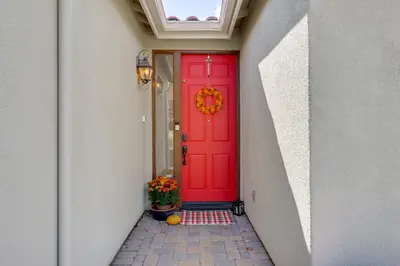a red door in a hallway with a potted plant at 13 Mi to Slopes Cozy Home with Fenced Yard in Reno in Reno