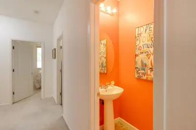 a bathroom with orange walls and a sink at 13 Mi to Slopes Cozy Home with Fenced Yard in Reno in Reno