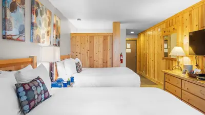a hotel room with two beds and a television at Cozy Northstar Village Escape w Forest Views Easy Lift Access Alpineglow Vista by AvantStay in Truckee