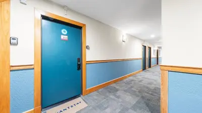 a hallway of an office with a blue door at Cozy Northstar Village Escape w Forest Views Easy Lift Access Alpineglow Vista by AvantStay in Truckee
