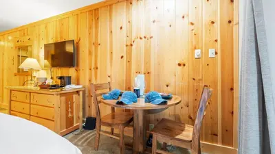 a room with a table and a desk and a bed at Cozy Northstar Village Escape w Forest Views Easy Lift Access Alpineglow Vista by AvantStay in Truckee