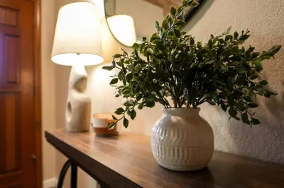 a table with a vase with a plant on it at Magic Sequoia Spacious Home in Three Rivers