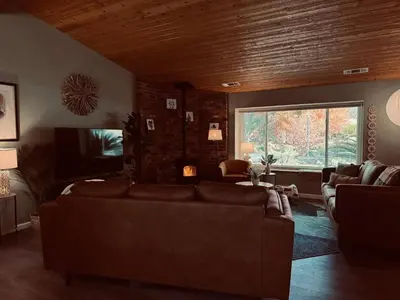 a living room with a couch and a large window at Magic Sequoia Spacious Home in Three Rivers