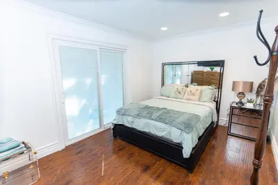 a bedroom with a bed and a large window at Sac Camp Delta Garden Retreat in Sacramento