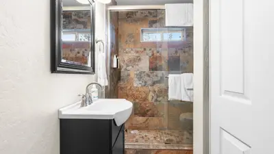 a bathroom with a sink and a shower at Steps to Trails Minutes to Heavenly Fireplace Deck BBQ Bluewood Cabin by AvantStay in South Lake Tahoe