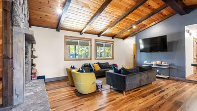 a living room with a couch and a tv at Steps to Trails Minutes to Heavenly Fireplace Deck BBQ Bluewood Cabin by AvantStay in South Lake Tahoe