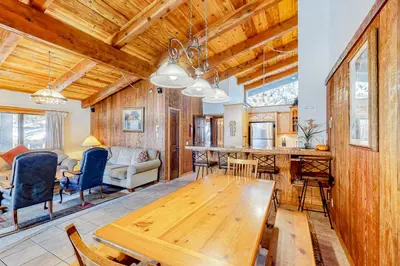 a dining room and living room with a wooden ceiling at Chateau Sans Nom 12 in Mammoth Lakes