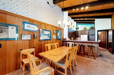 a dining room with a wooden table and chairs at Chateau Sans Nom 11 in Mammoth Lakes