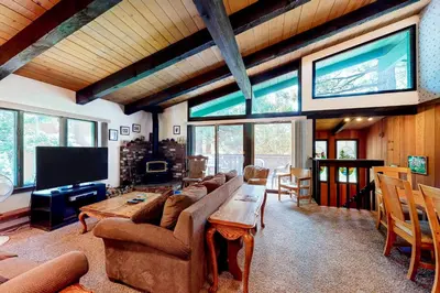 a living room with a large couch and a tv at Chateau Sans Nom 11 in Mammoth Lakes