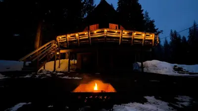 a lit candle in front of a house at night at Little Bear Lodge in Springville