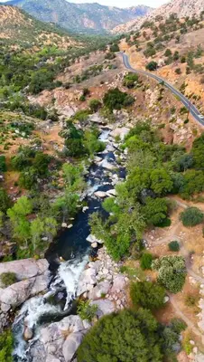 an aerial view of a river with trees and a road at Little Bear Lodge in Springville