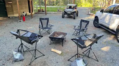 a group of chairs and a grill and a jeep at Little Bear Lodge in Springville