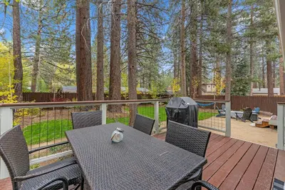 a patio with a table and chairs on a deck at CYH0883- Patricia's Mountain Paradise home in South Lake Tahoe