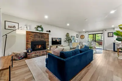 a living room with a blue couch and a fireplace at CYH0883- Patricia's Mountain Paradise home in South Lake Tahoe