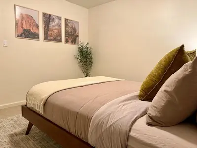 a bedroom with a bed with a plant on it at Relax Under the Stars, Best view in town , Yosemite House with Firepit, Hot Tub, Game Room & Pool table in Oakhurst
