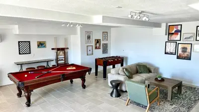 a living room with a pool table and a couch at Relax Under the Stars, Best view in town , Yosemite House with Firepit, Hot Tub, Game Room & Pool table in Oakhurst