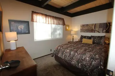 a bedroom with a large bed and a window at HCH0864 - Donner Cabin home in South Lake Tahoe