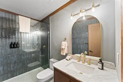 a bathroom with a sink and a toilet and a shower at Charming Tahoe Cabin in Incline Village